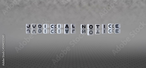 judicial notice word or concept represented by black and white letter cubes on a grey horizon background stretching to infinity