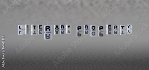 literary property word or concept represented by black and white letter cubes on a grey horizon background stretching to infinity