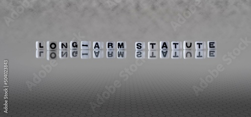 long arm statute word or concept represented by black and white letter cubes on a grey horizon background stretching to infinity