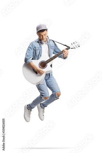 Energetic guy jumping and playing an acoustic guitar