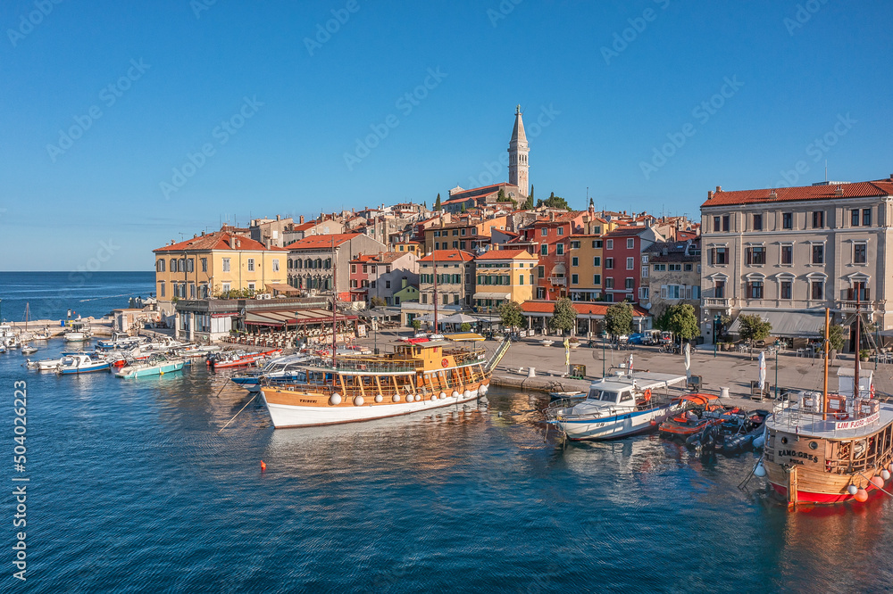 ROVINJ, CROATIA - August 19th, 2021: Many boats in the harbour near olld town of Rovinj, popular travel destination in Croatia