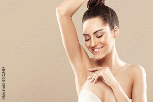 Beauty portrait. Armpit epilation, lacer hair removal. Young woman showing clean underarms.