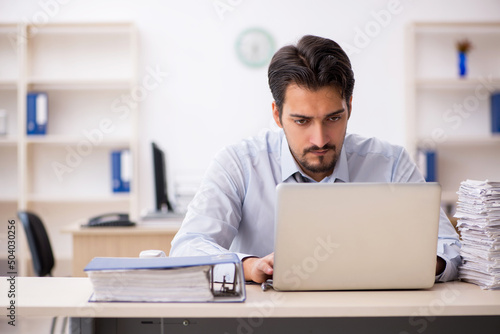 Young male employee working in the office