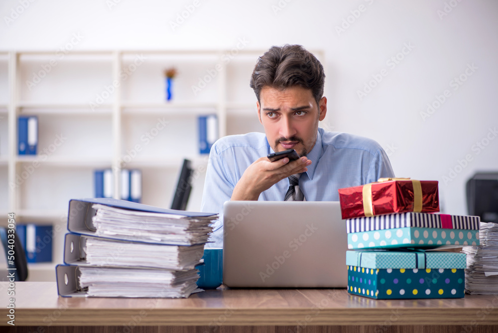 Young male employee celebrating birthday at workplace Young male employee celebrating birthday at workplace