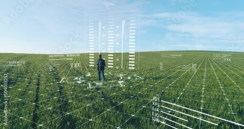 Caucasian bearded farmer in casual clothes and cap using holograms with digital tablet on green field. Concept of people, futuristic technology and augmented reality.