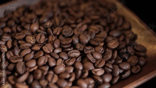Wallpaper Mural a set of coffee beans after roasting in a coffee shop in a wooden cup on a black background spinning in the dark Torontodigital.ca