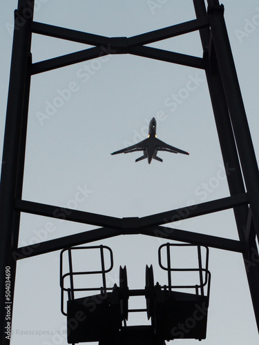 Plane flying through crane