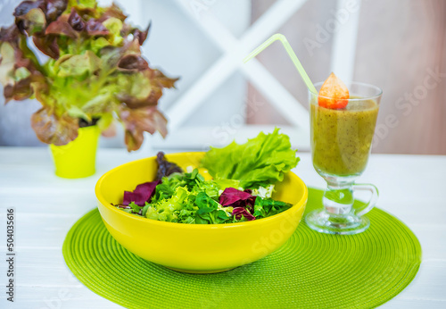 Natural smoothies and green salad. The concept of proper nutrition and a healthy lifestyle

