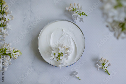 cream cosmetic lilac flower background