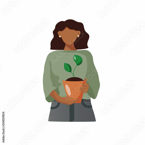 Dark skinned girl carefully holding young plant. 