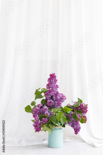 Bouquet of Lilacs in a Vase isolated on white. Branch with Lilac Flowers.