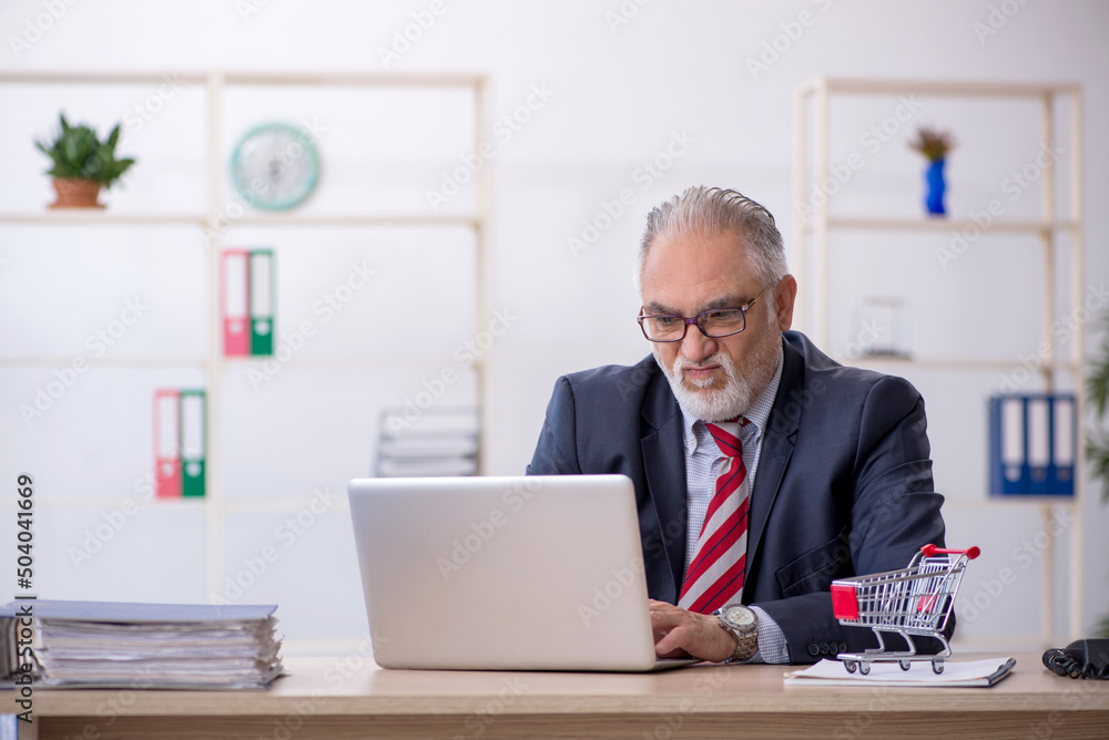 Old male employee in e-commerce concept Old male employee in e-commerce concept