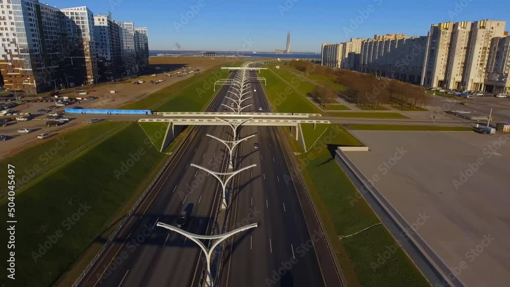 Drone span over high-speed road in the early morning, northwest high-speed diameter, bypass road, green lawns on the edges of the highway connecting the bridge to the residential area Drone span over high-speed road in the early morning, northwest high-speed diameter, bypass road, green lawns on the edges of the highway connecting the bridge to the residential area