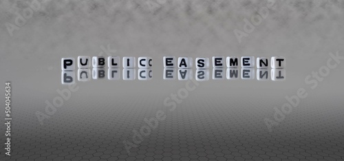 public easement word or concept represented by black and white letter cubes on a grey horizon background stretching to infinity photo