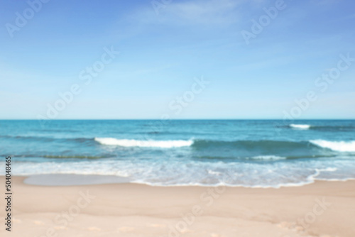 Blurred view of beautiful sea and sandy beach on sunny day