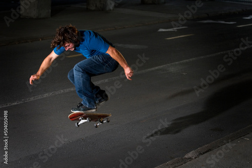 Skateboarder doing a flip on street