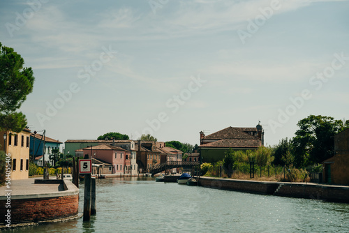 View of the San Michele Arcangelo bell tower and the colorful houses of Mazzorbo, Venice - sep, 2021 photo