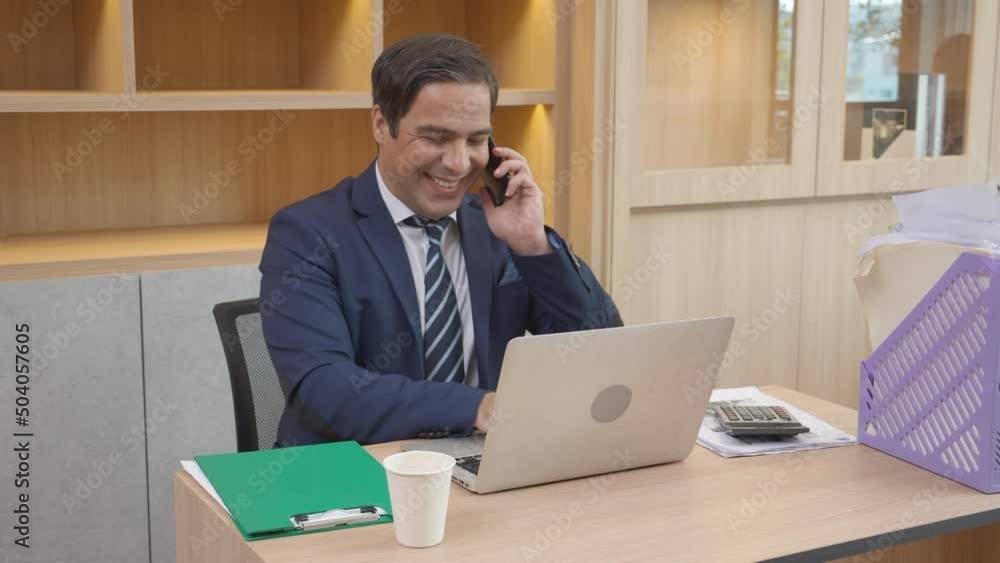 Executive or manager busy working on laptop computer and talking smartphone with happiness while success in the office, businessman telephone call with confident at corporate, business concept. Executive or manager busy working on laptop computer and talking smartphone with happiness while success in the office, businessman telephone call with confident at corporate, business concept.