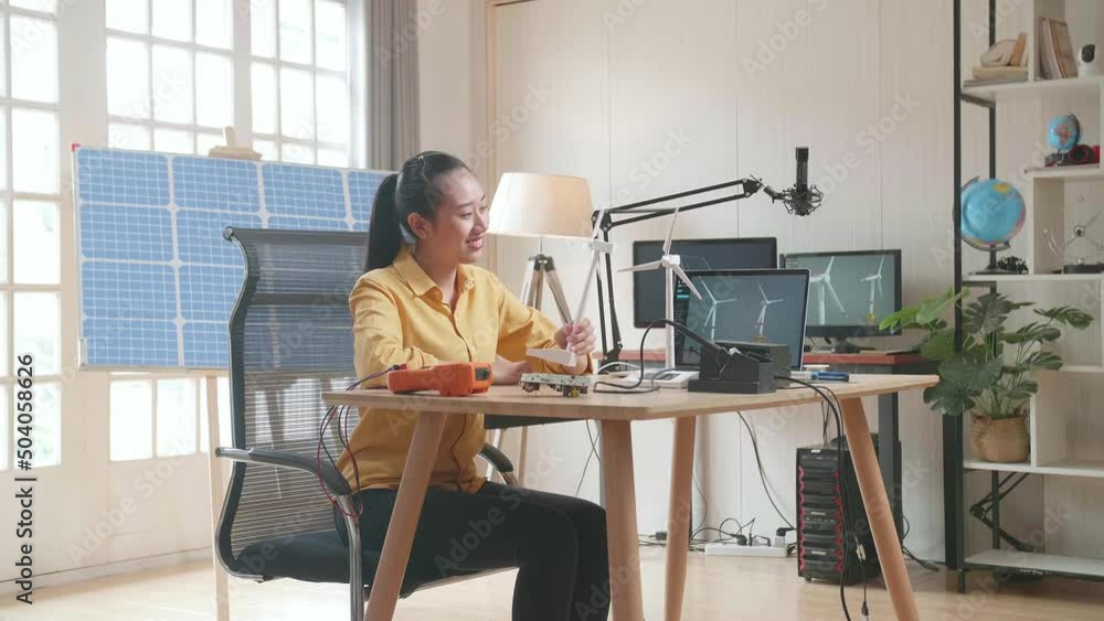 Asian Woman Look At Wind Turbine And Smile To Camera While Working With Laptop Next To The Solar Cell At The Office
Asian Woman Look At Wind Turbine And Smile To Camera While Working With Laptop Next To The Solar Cell At The Office
