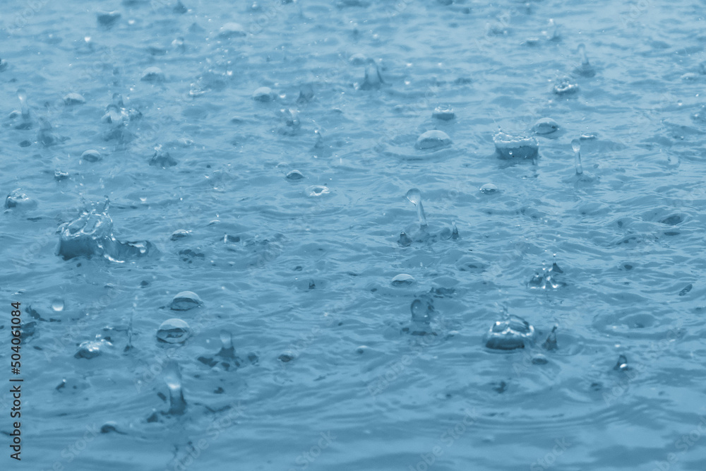 blue color tone of close up rain water drop falling to the floor blue color tone of close up rain water drop falling to the floor