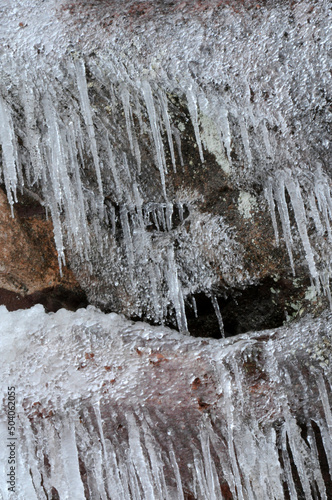 Melting icicles on sandstone rocks with lichen at Red Rocks Park in Morrison Colorado