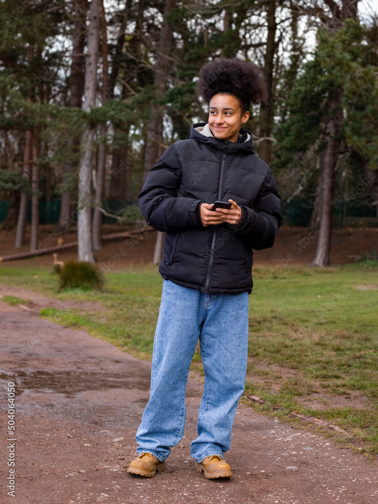 Fototapeta premium Girl using mobile phone in park
