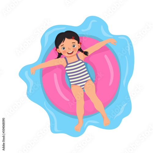 happy cute little girl with swimsuit lying on inflatable rubber ring having fun floating in swimming pool on summer time