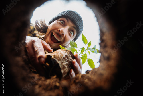 Quadro em tela Excited male gardener planting flower
