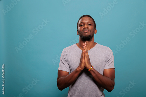Canvas Print Religious man holding hands in prayer sign to worship God, having faith in Jesus and christianity