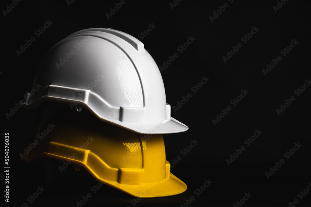 Safety helmet engineer white and yellow on black background Safety helmet engineer white and yellow on black background