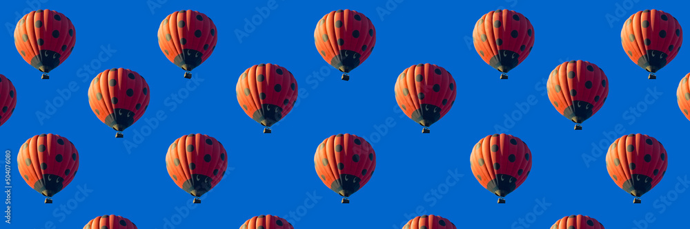 Obraz premium Red hot air balloon banner decorated as ladybird flying in clear blue sky