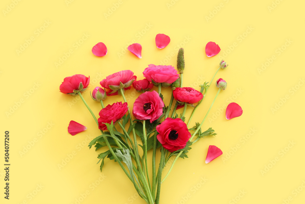 Fototapeta premium Top view image of pink flowers composition over yellow background