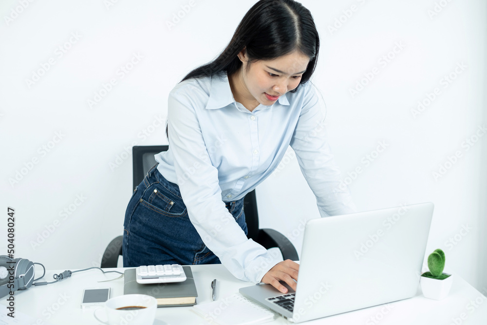 Asian woman working laptop. Successful smiling happy businesswoman working at the office Asian woman working laptop. Successful smiling happy businesswoman working at the office