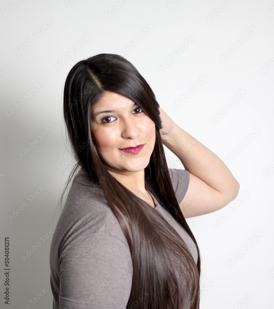 Overweight Latin young adult woman shows how silky and shiny her black hair is, very long, straight, which she takes in her hands, very happy and proud of the beautiful hair with a beautiful haircut Overweight Latin young adult woman shows how silky and shiny her black hair is, very long, straight, which she takes in her hands, very happy and proud of the beautiful hair with a beautiful haircut