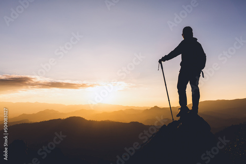 Silhouette of a woman standing on a mountain concept of leadership, success, hiking.