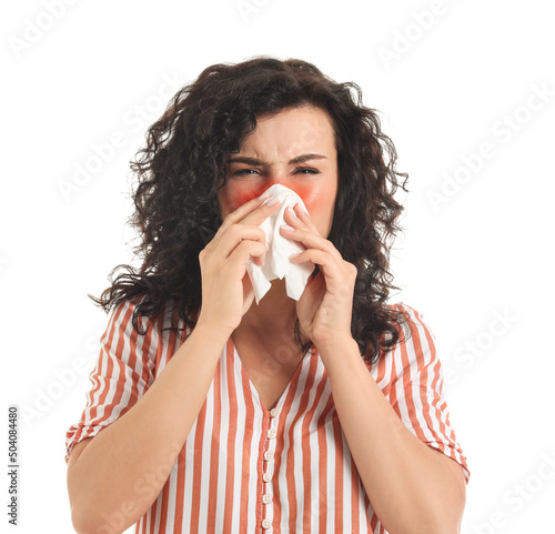 Sneezing young woman on whi...