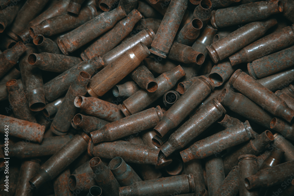 A lot of used old, rusty brass cartridge cases from the machine. Empty carbine or rifle cartridges. Background of brass ammunition cartridges to illustrate armed conflict, war or shooting.
A lot of used old, rusty brass cartridge cases from the machine. Empty carbine or rifle cartridges. Background of brass ammunition cartridges to illustrate armed conflict, war or shooting.