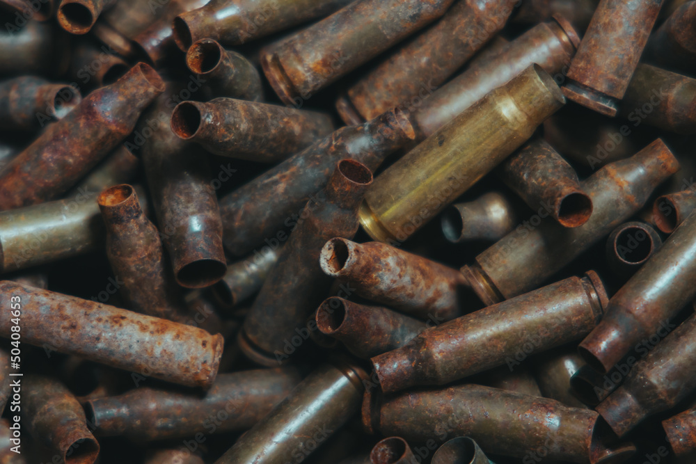 A lot of used old, rusty brass cartridge cases from the machine. Empty carbine or rifle cartridges. Background of brass ammunition cartridges to illustrate armed conflict, war or shooting.
A lot of used old, rusty brass cartridge cases from the machine. Empty carbine or rifle cartridges. Background of brass ammunition cartridges to illustrate armed conflict, war or shooting.