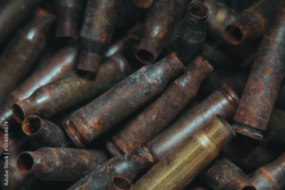 A lot of used old, rusty brass cartridge cases from the machine. Empty carbine or rifle cartridges. Background of brass ammunition cartridges to illustrate armed conflict, war or shooting.
A lot of used old, rusty brass cartridge cases from the machine. Empty carbine or rifle cartridges. Background of brass ammunition cartridges to illustrate armed conflict, war or shooting.