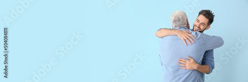 Happy young man hugging his...