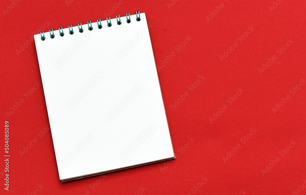 Blank notepad and on office red table Blank notepad and on office red table