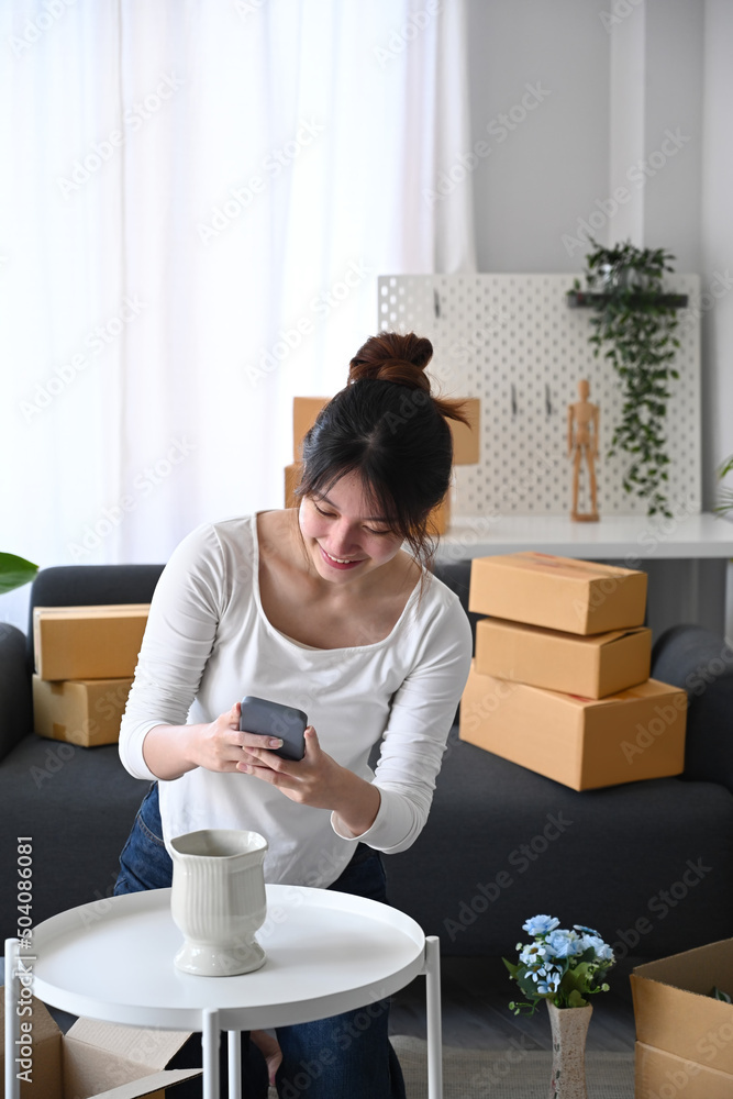 Young start up small business entrepreneur using smartphone take a photo of product for upload to website online shop. Young start up small business entrepreneur using smartphone take a photo of product for upload to website online shop.