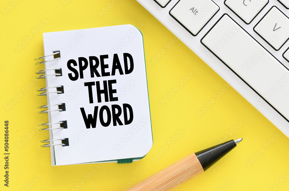 SPREAD THE WORD words written in an office notebook. Concept for business. SPREAD THE WORD words written in an office notebook. Concept for business.