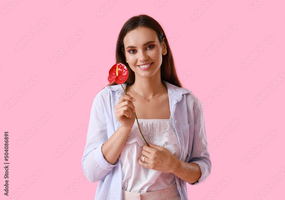 Happy woman with beautiful anthurium flower on color background Happy woman with beautiful anthurium flower on color background
