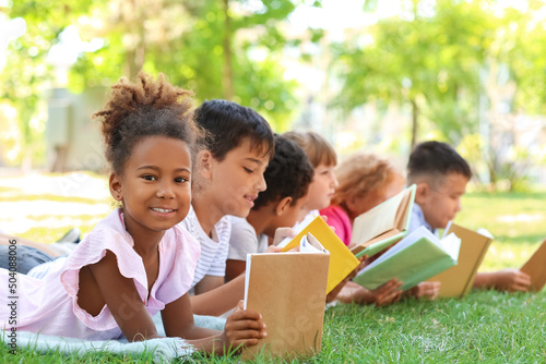 Cute little children reading books in park © Pixel-Shot