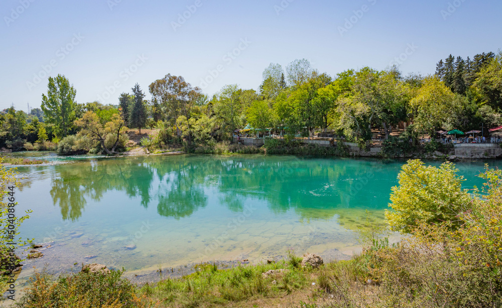 Backwater with emerald water behind the Manavgat waterfall in Side, Turkey