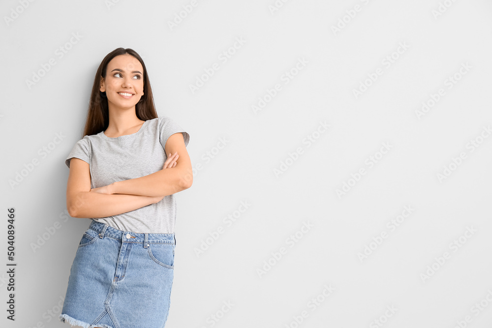 Pretty young woman in stylish t-shirt on light background Pretty young woman in stylish t-shirt on light background