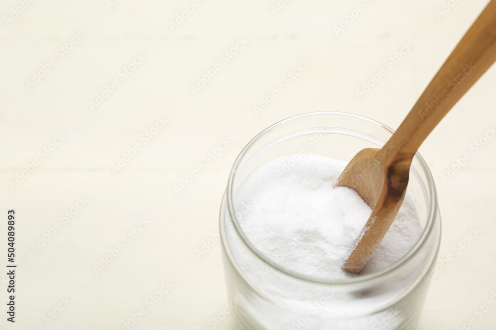 Jar with baking soda on white wooden background, closeup Jar with baking soda on white wooden background, closeup