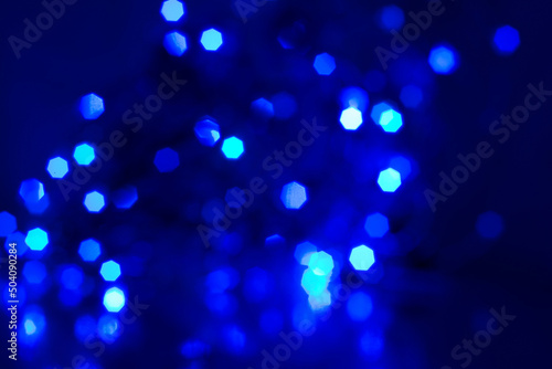 blue dark background with blurred sparks led christmas garlands