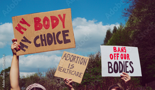 Protesters holding signs My Body My Choice, Bans Off Our Bodies, Abortion Is Healthcare. People with placards supporting abortion rights at protest rally demonstration. © Longfin Media